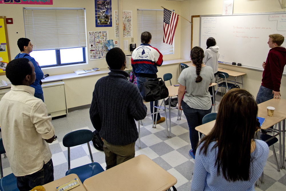 Students in the homeroom of Will Leque, a mathematics teacher at Westbrook High School, recite the Pledge of Allegiance before the start of school.