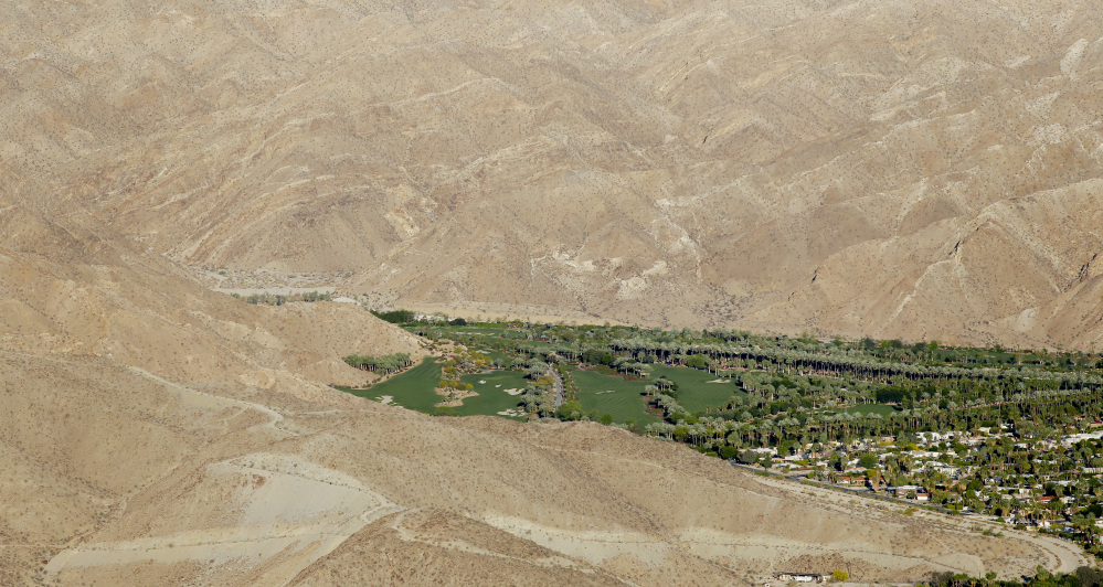 This aerial photo shows the Porcupine Creek Golf Club bordering the desert in Rancho Mirage, Calif. California Gov. California cities face mandatory targets to slash water use as much as 35 percent while regulators warn voluntary conservation hasn’t been enough in the face of a devastating drought.