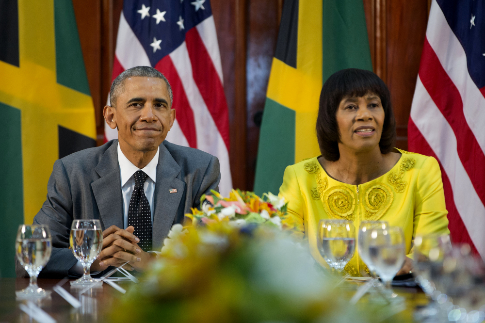 President Obama, left, and Jamaican Prime Minister Portia Simpson-Miller meet at the Jamaica House on Thursday, in Kingston, Jamaica. The president said Thursday that he will soon decide whether to remove Cuba from the U.S. list of state sponsors of terrorism now that the State Department has finished a review on the question as part of the move to reopen diplomatic relations with the island nation.