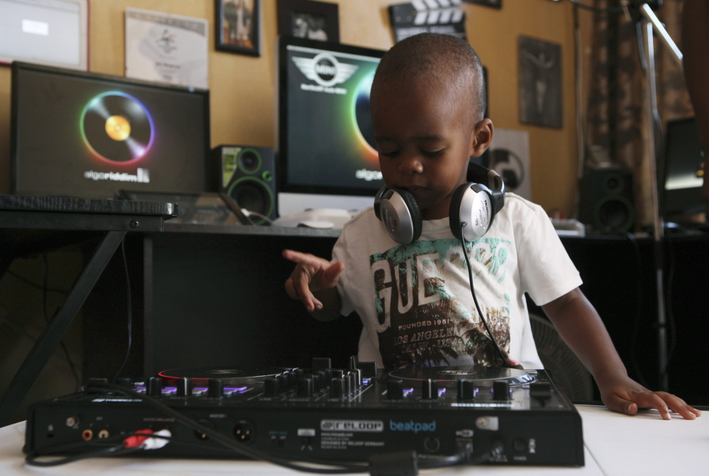 Known to 25,000 Facebook fans as DJ AJ,  2-year-old Oratilwe Hlongwane, manipulates the buttons and knobs of a sophisticated music system.