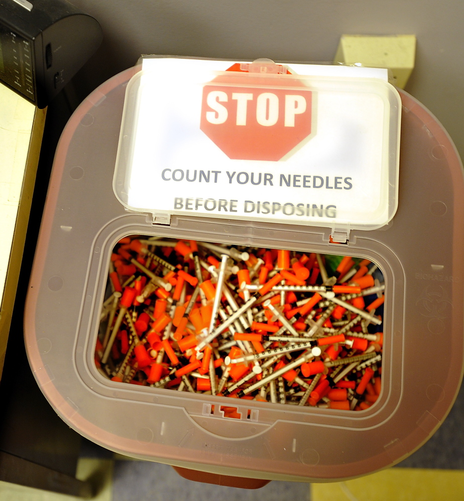 A box in the needle exchange room at Portland’s India Street Public Health Center contains discarded needles. The clinic distributes one-third of the needles in the state.