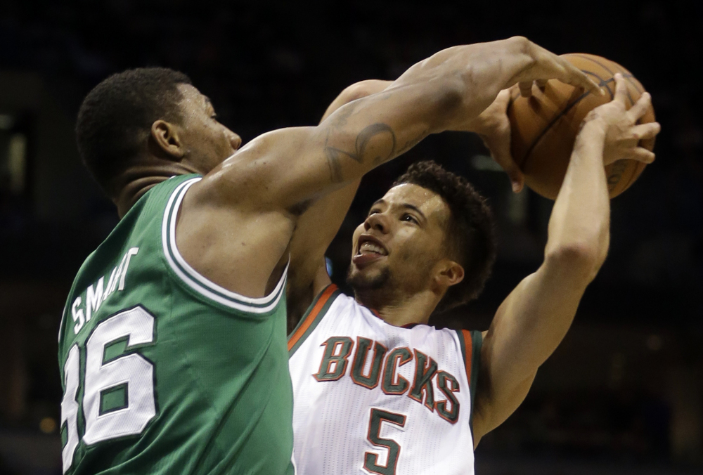 The Milwaukee Bucks’ Michael Carter-Williams is covered closely by the Celtics’ Marcus Smart while he tries to take a shot in the first half of Wednesday night’s game in Milwaukee. The Celtics finished their surprising regular season with a win, and now move on to the playoffs this weekend.
