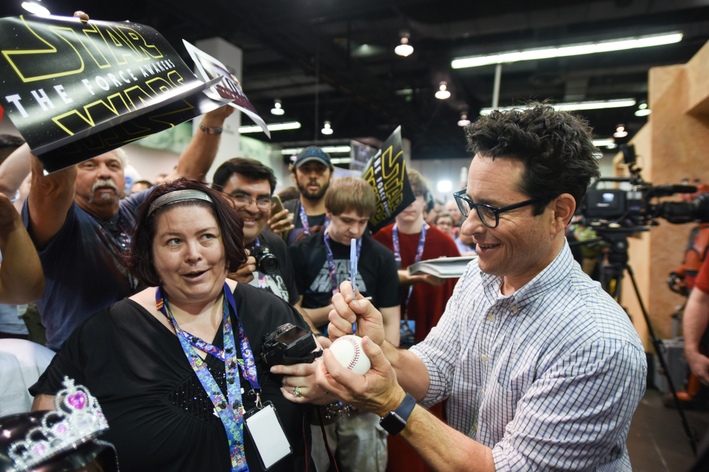 Filmmaker J.J. Abrams signs autographs for fans on the Cantina set Thursday at Star Wars Celebration: The Ultimate Fan Experience.