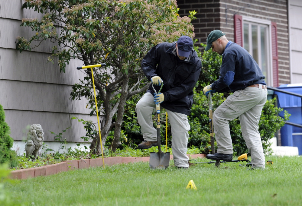 Law enforcement agents dig in the front yard of the home of Robert Gentile in Manchester, Conn., on May 10, 2012. The reputed Connecticut mobster is allegedly linked to artwork stolen from Boston’s Isabella Stewart Gardner Museum in 1990.