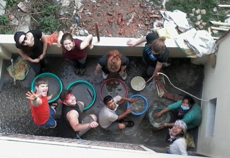 Ben Hichens of South Berwick, lower left, and other members of Biddeford-based 360 Maine build a water filtration system for residents of Bhaktapur, Nepal, on March 26.