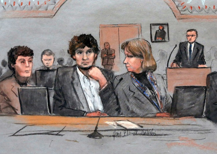 Dzhokhar Tsarnaev, center, is depicted in a courtroom sketch between defense attorneys Miriam Conrad, left, and Judy Clarke, right, during his federal death penalty trial in Boston. He was found guilty on all 30 counts. 