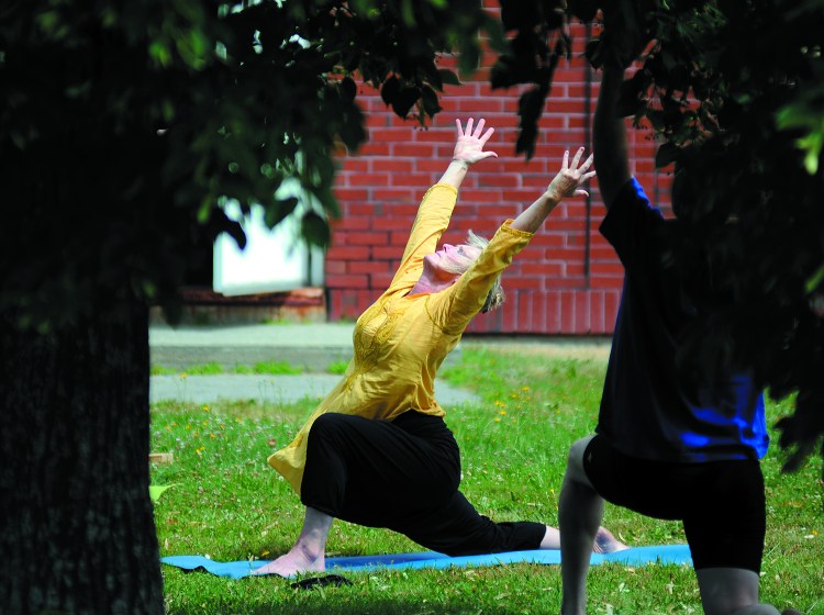 Dawn Habash leads a yoga class on the lawn of the Eastside Wellness Center in Augusta.