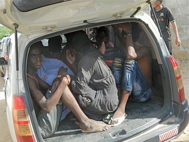 Garissa University College students take cover in the back of a truck after escaping from gunmen who attacked the campus early Thursday, shooting indiscriminately. The Associated Press