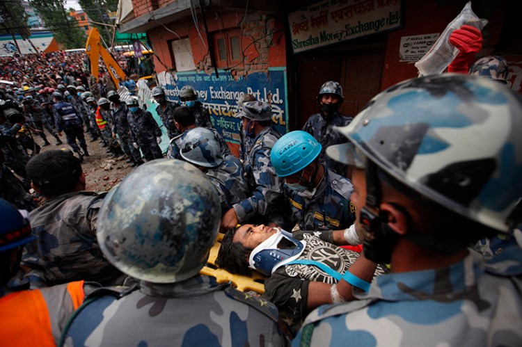 Crowds cheered Thursday as teenager Pemba Tamang was pulled, dazed and dusty, from the wreckage of a seven-story Kathmandu building that collapsed around him five days ago.