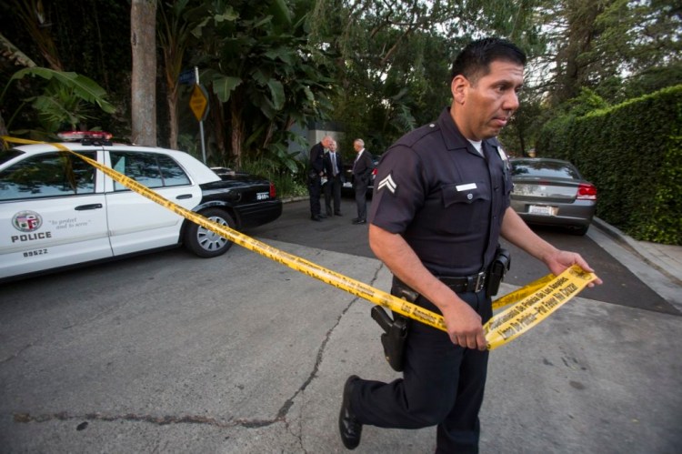 A police officer creates a perimeter outside the home of Andrew Getty in the Hollywood Hills area of Los Angeles Tuesday. 