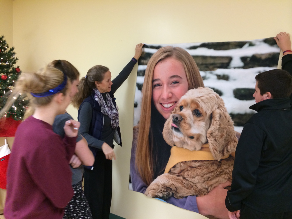 Volunteers with the Mount Merici Young Alums decorate the Waterville Area Humane Society in December in memory of Cassidy Charette, of Oakland, whose picture was also hung. Charette died in a Halloween hayride accident last fall, and that case goes to an Androscoggin County grand jury next week.