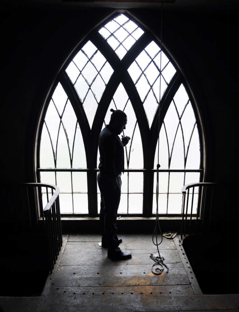 David Boucher stands in the bell tower talking on his cell phone to set up utilities in the former church that his company Lost Orchard Brewery bought to use as a tasting room on Thursday in Gardiner.