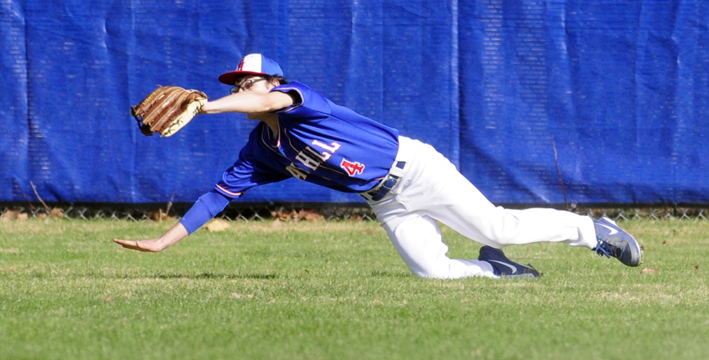 Oak Hill left fielder Kaleb Morrisette makes a diving catch during a game against Dirigo on Friday in Wales.