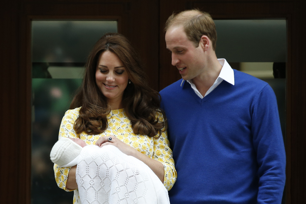 Britain’s Prince William, right, and Kate, Duchess of Cambridge, with their newborn daughter pose for the media outside St. Mary’s Hospital’s exclusive Lindo Wing, London, on Saturday. The Duchess gave birth to the Princess on Saturday morning.