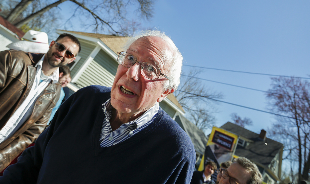 Presidential hopeful Sen. Bernie Sanders makes his way in to a house party in Manchester, N.H., on Saturday.