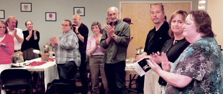 Staff members, volunteers and board members applaud on Sunday after Betty Palmer, right, executive director of the Mid-Maine Homeless Shelter, announced a campaign to expand and improve the Waterville facility during a volunteer celebration and annual meeting. Standing beside Palmer are incoming board chairwoman Susan Reisert and outgoing chairman Dirk Kershner.