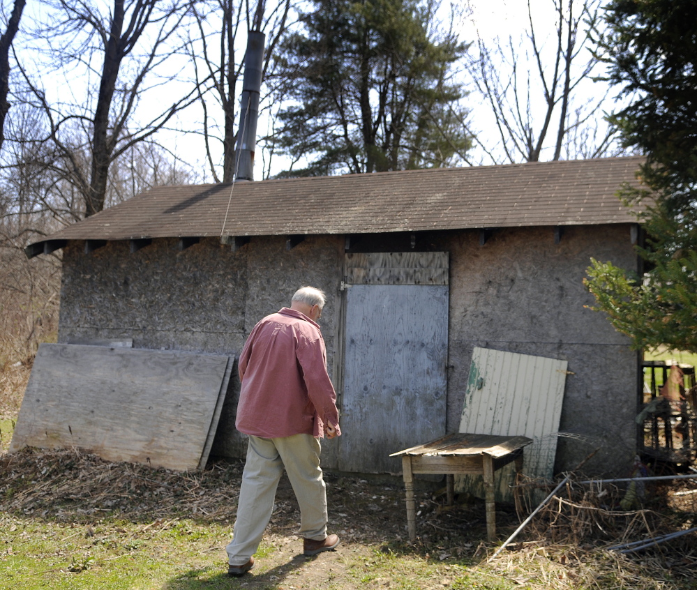 Neal Loken heads to the gas-fired kiln building Sunday at the pottery studio behind his Farmingdale home. Loken Pottery was open for tours during the Maine Pottery Tour, as were several other shops in Maine.