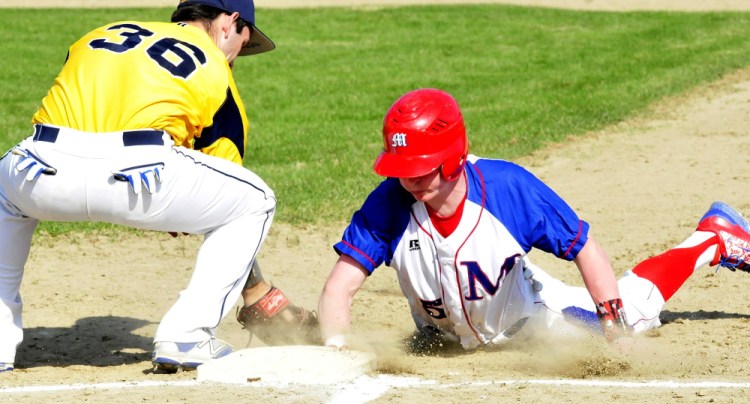 Messalonskee’s Trevor Getting just slides back to first base safely as Mt. Blue’s Corey Rogers attempts applies a tag during a Kennebec Valley Athletic Conference Class A game Monday afternoon.