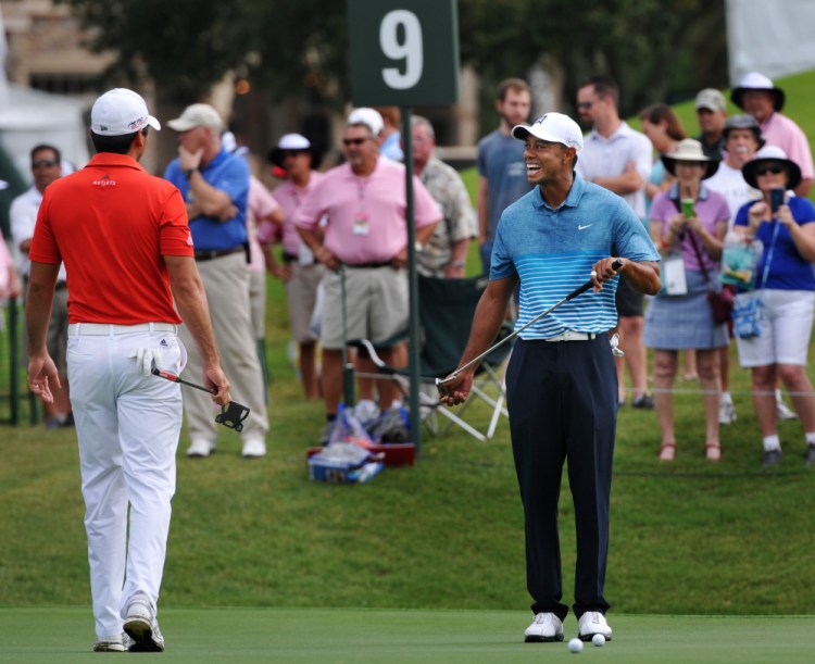 Tiger Woods, right, chats with Jason Day on the ninth green Tuesday during a practice round for The Players Championship in Ponte Vedra Beach, Fla.