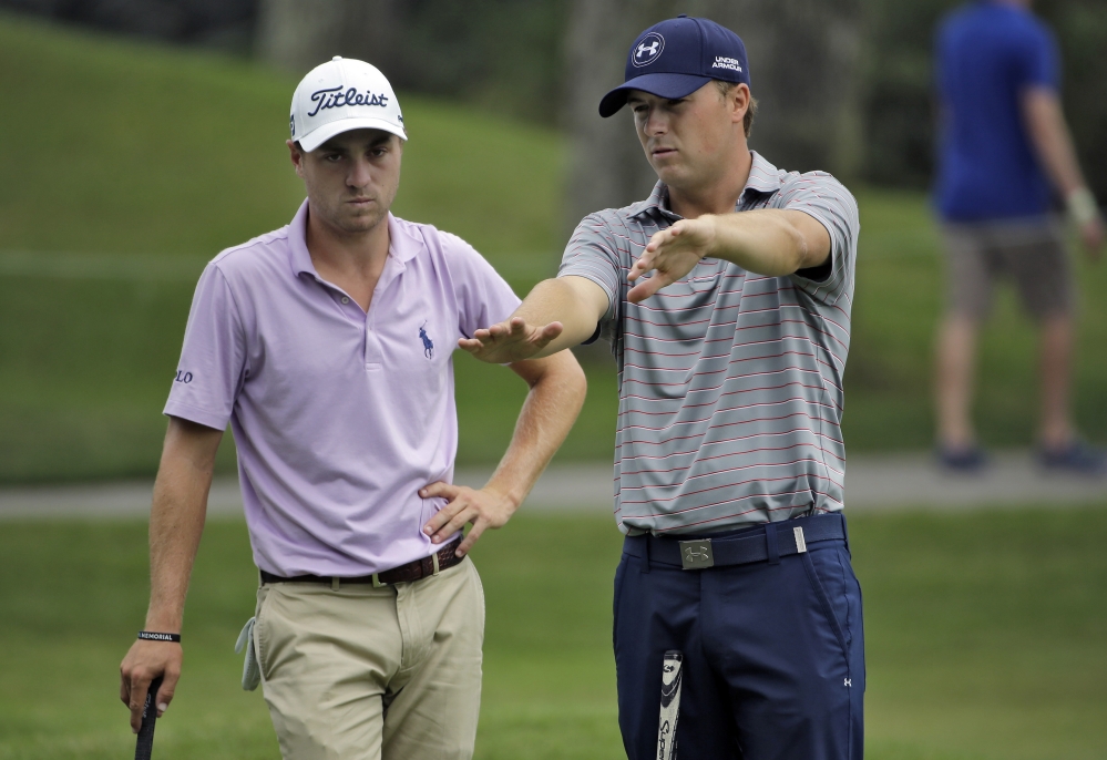 Jordan Spieth, right, explains the break on the 15th green to Justin Thomas during a practice round Wednesday at The Players Championship in Ponte Vedra Beach, Fla.