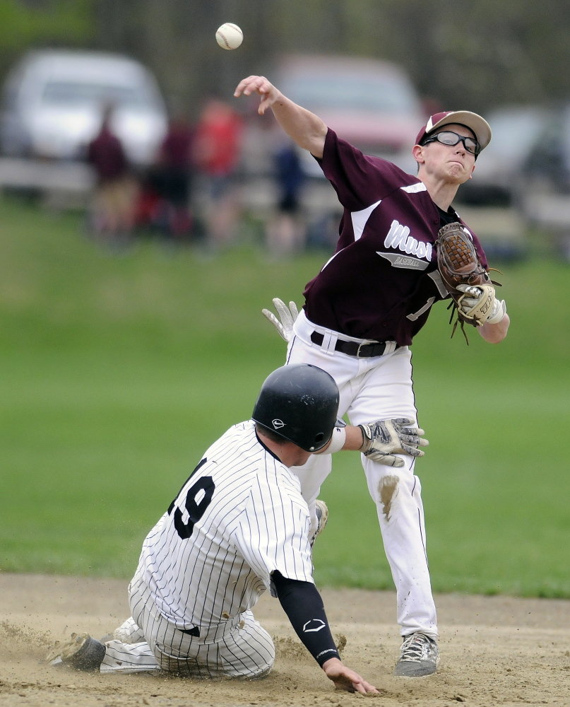 Monmouth Academy’s Mat Foulke attempts to turn two after making the tag at second during a game against St. Dom’s on Monday afternoon.