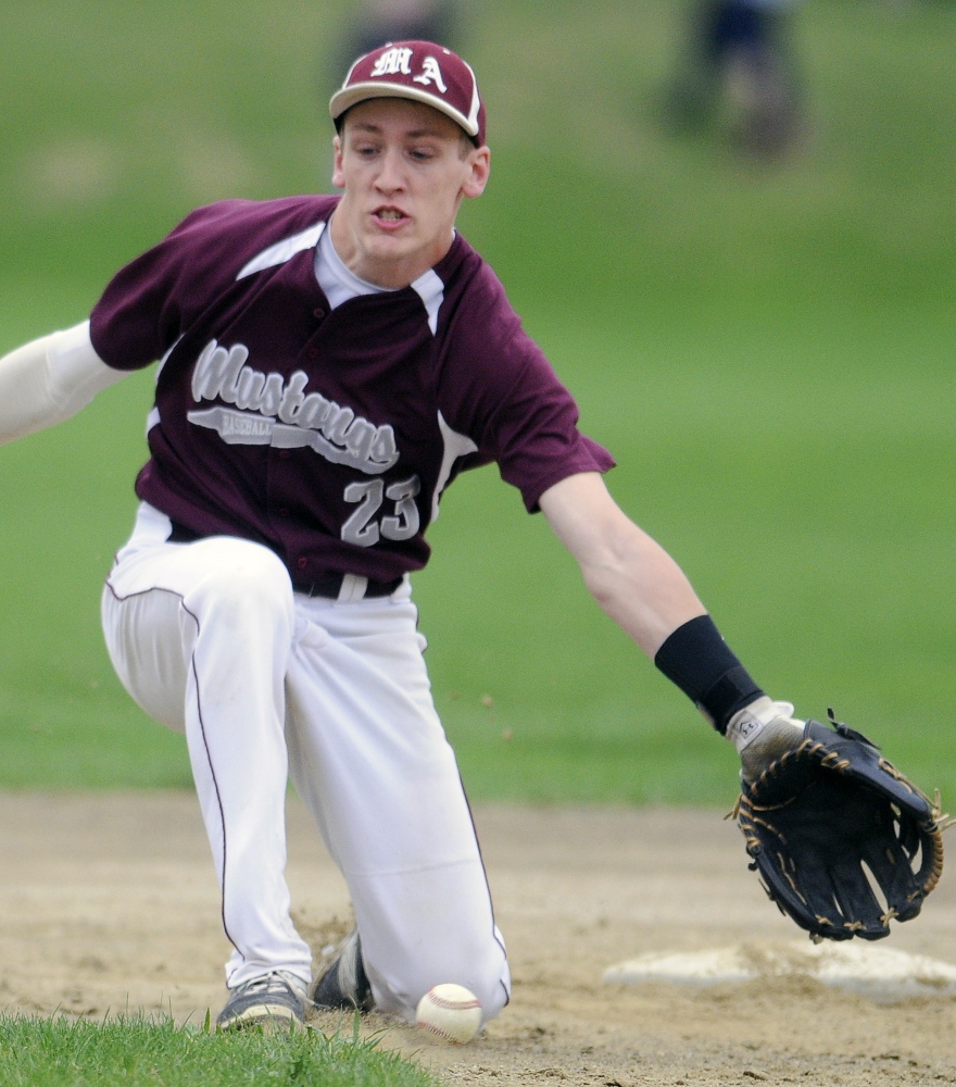 Monmouth Academy’s Hunter Richardson can’t collect a grounder during a Mountain Valley Conference game Monday against St. Dom’s.