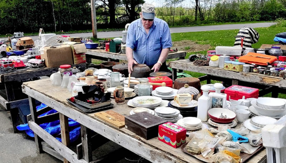 The Cornville 10-Mile Yard Sale opens for its 32nd year on Saturday, bringing treasure seekers together with vendors such as Philip Goodell of Cornville, seen in this file photo setting up his merchandise for the 2012 sale at his home on the West Ridge Road in Cornville.