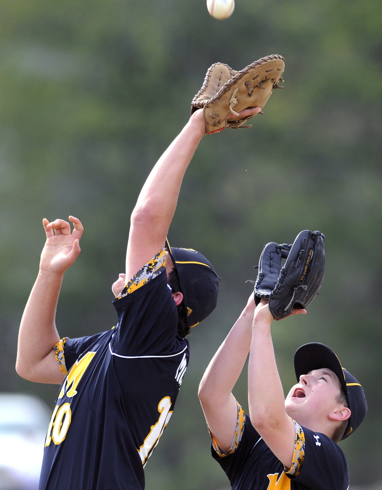 Maranacook’s Matt Gyorgy, right, backs up first baseman Logan McLaughlin with a pop up during a game Tuesday afternoon against Camden Hills in Readfield. Camden scored six runs in the top of the seventh to earn an 8-4 victory.