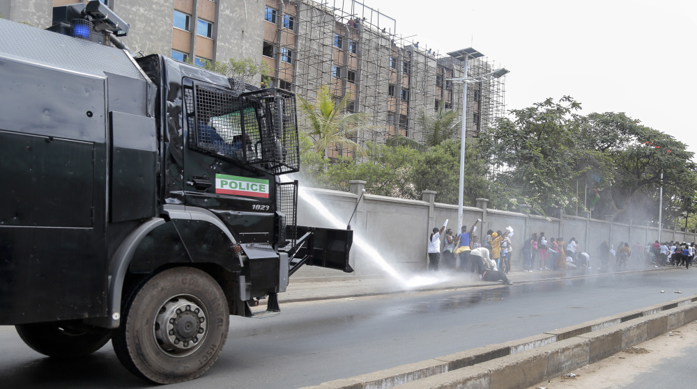 A police water-cannon disperses women demonstrators as they try to march to the town center, in the Ngagara district of Bujumbura, Burundi Wednesday.
