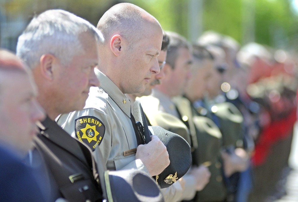 Law enforcement officers, including Penobscot County Chief Deputy William Sheehan, listen Thursday during the annual police memorial ceremony in Augusta.