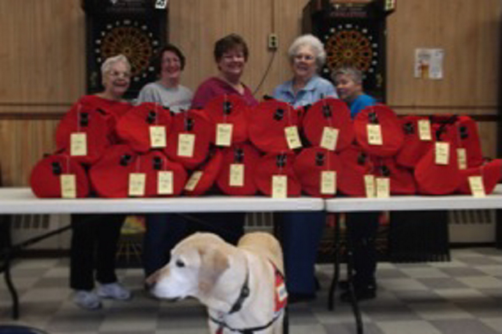 American Legion Auxiliary Unit 39 members from Madison donated their time to fill the 20 duffel bags for DHHS. From left are Betty Dow, Harriet Bryant, Robin Turek, Marie Wing and Merrilyn Vieira. Colonel, service dog to Turek, is in the front.
