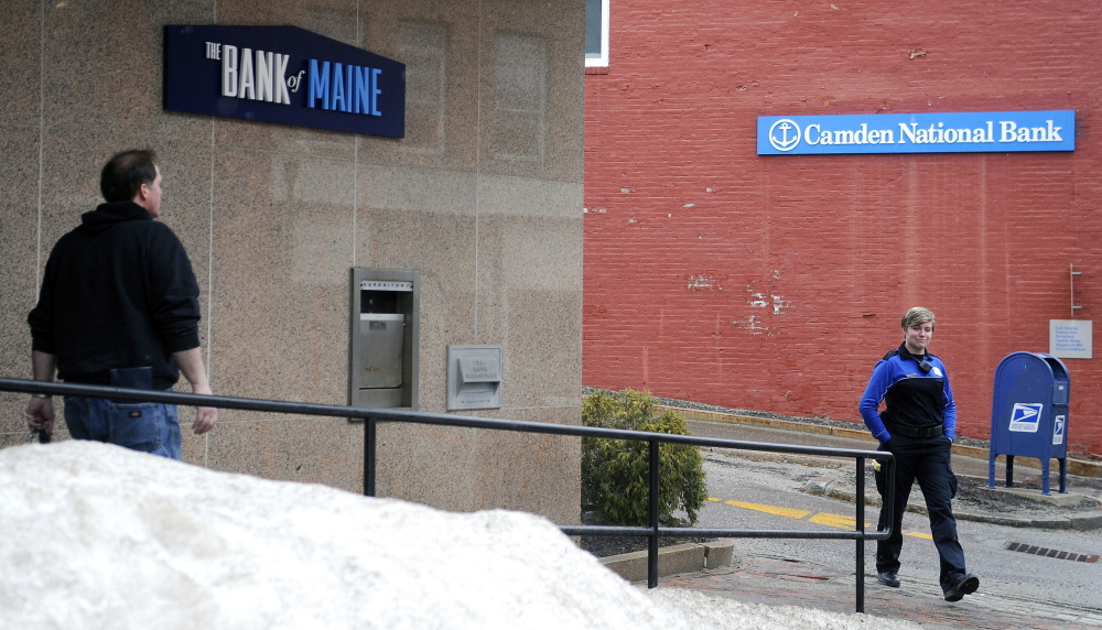 People walk out of The Bank of Maine branch, left, and Camden National Bank on Water Street in Gardiner in this March file photo. Camden National announced Friday that it plans to consolidate bank branches that are near each other, including these locations in Gardiner.