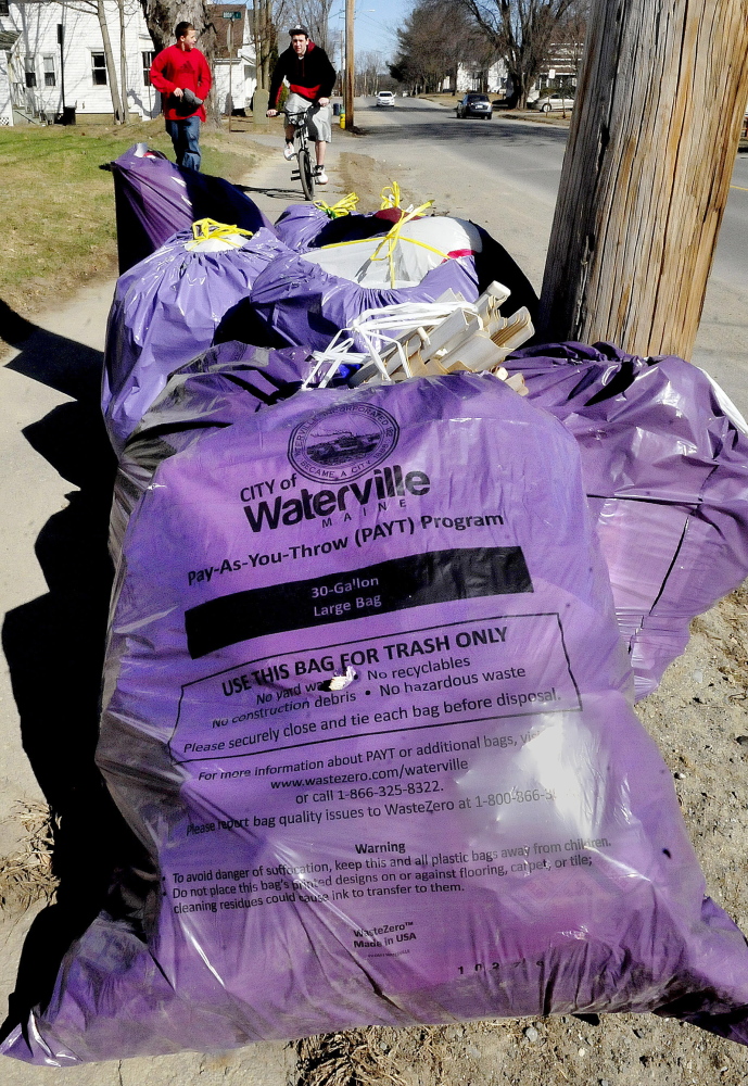 Purple bags of trash used in the pay-as-you-throw trash program in Waterville are set curbside for pick up on Western Avenue on April 15.