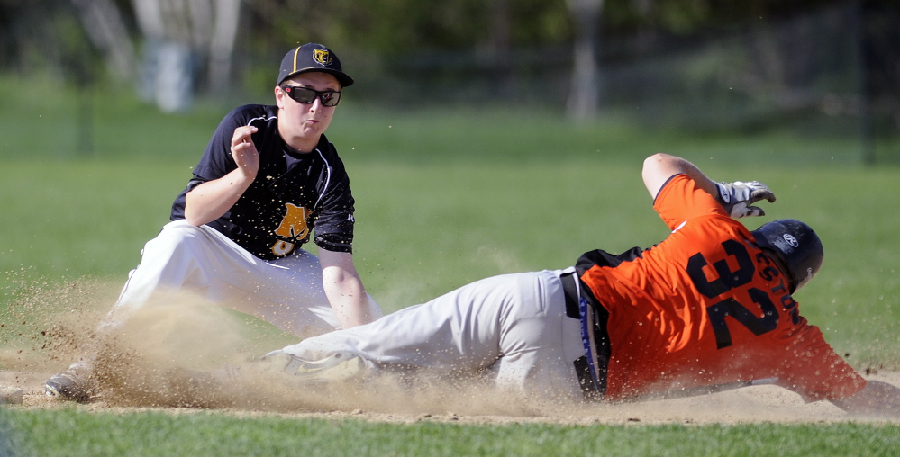Gardiner Area High School baserunner Brad Weston beats the tag of Maranacook second baseman Matt Gyorgy at second during a game Monday afternoon in Readfield.