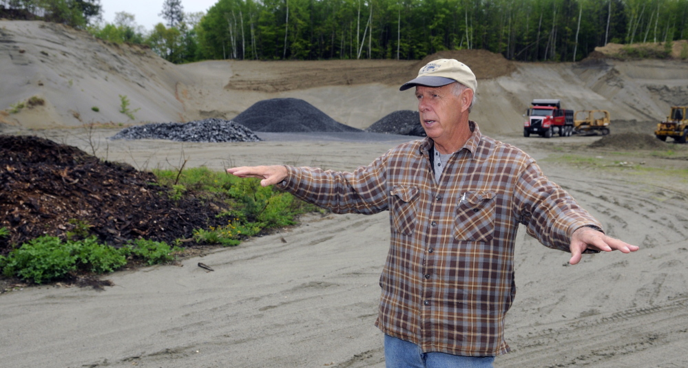 Belgrade Board of Selectpersons Chairman Ernie Rice stands on the site of a proposed new Town Office on Tuesday. The site is on Route 27 and is now a sand pit.