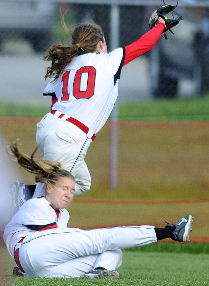Hall-Dale High School’s Olivia Maynard, bottom, collides with Mt. Abram’s Nicole Bodge while pursing a popup in left field during a Mountain Valley Conference game against Hall-Dale on Wednesday in Farmingdale. Bodge was knocked to the ground but came up with the catch.