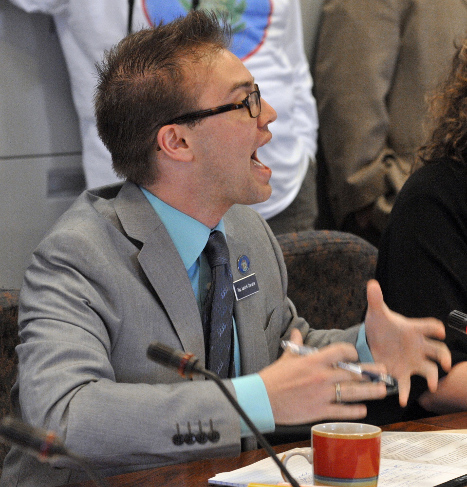 Rep. Justin Chenette, D-Saco, asks a question of Rep. Diane M. Russell, D-Portland, after she introduced her bill, L.D. 1380, “An Act To Legalize, Tax and Regulate Marijuana,” on Wednesday during a hearing before the Legislature’s Criminal Justice Committee in the State House in Augusta.