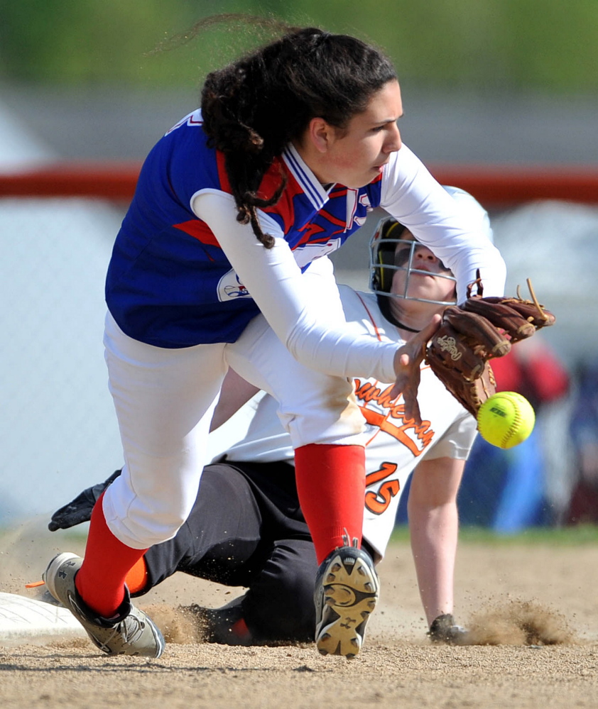 Skowhegan Area High School’s Chloe Thorndike (15) slides in to second base ahead of the ball as Messalonskee High School’s Kate Pino tries to field the ball Friday in Skowhegan.