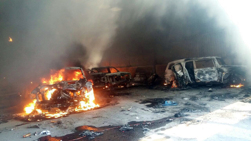 Vehicles burn, that authorities say caught fire during a gunbattle, in a warehouse at Rancho del Sol, near Ecuanduero, in western Mexico, Friday.