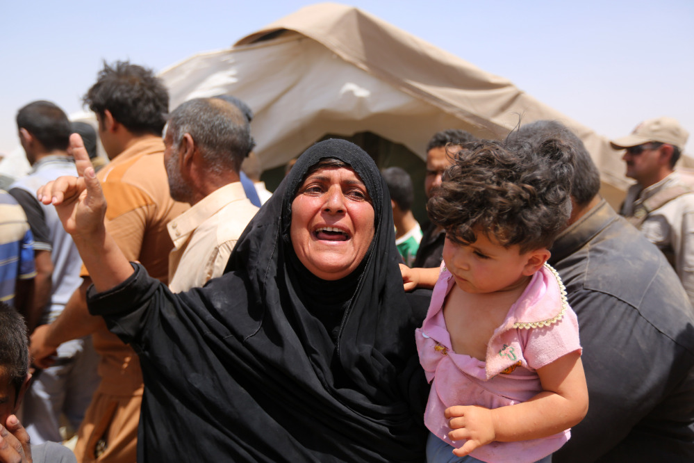 A women who fled Ramadi holds a child  in a camp in the town of Amiriyat al-Fallujah, west of Baghdad, Iraq, Friday.