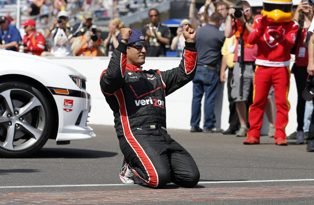 Juan Pablo Montoya, of Colombia, celebrates after winning the 99th running of the Indianapolis 500 auto race at Indianapolis Motor Speedway in Indianapolis, Sunday, May 24, 2015.  (AP Photo/Sam Riche)