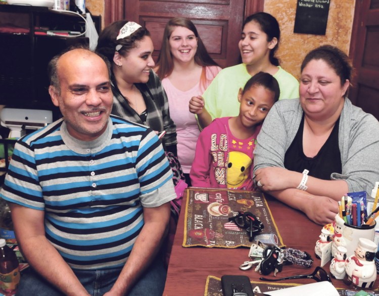 Florentino Santiago, of Winslow, will get a high school diploma Tuesday after completing courses with the Mid-Maine Regional Adult Education program. He and his wife, Mary, have six children and are seen here with daughter Crystal, left, family friend Jericha, daughter Carmen and granddaughter Niesha in front.