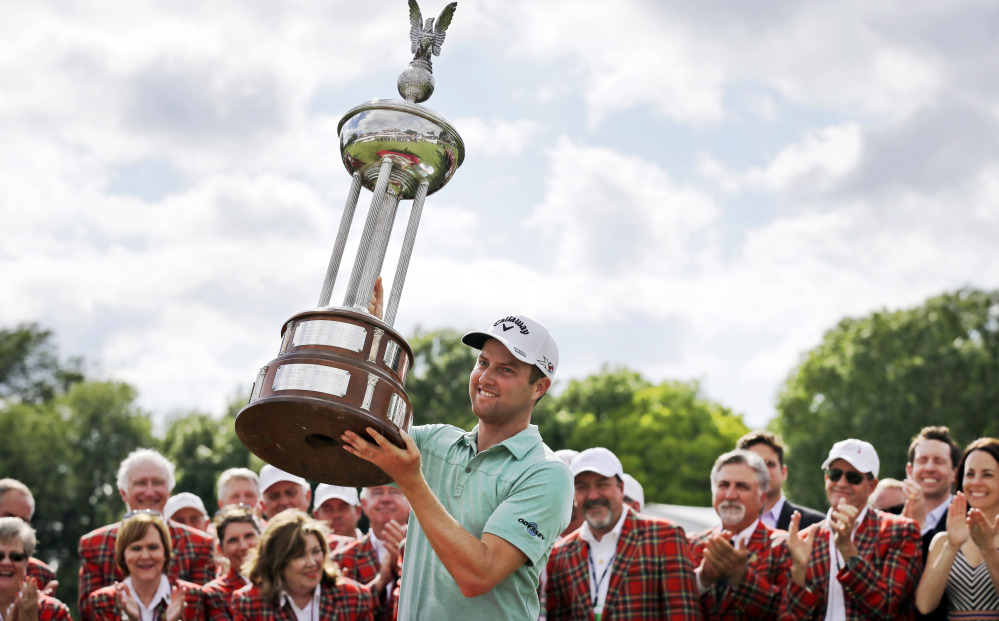 Chris Kirk lifts the trophy Sunday after winning the Colonial in Fort Worth, Texas.