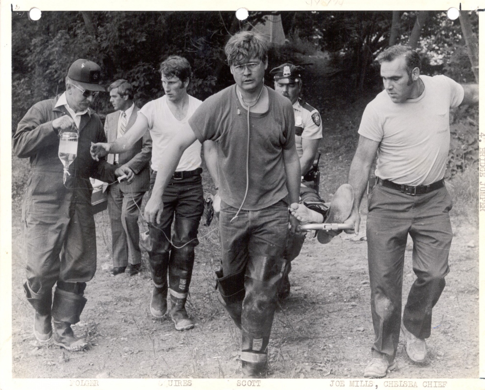 Augusta emergency services crews, including Charlie Squires on the left, transport a person who jumped off the Memorial Bridge in the early 1980s.