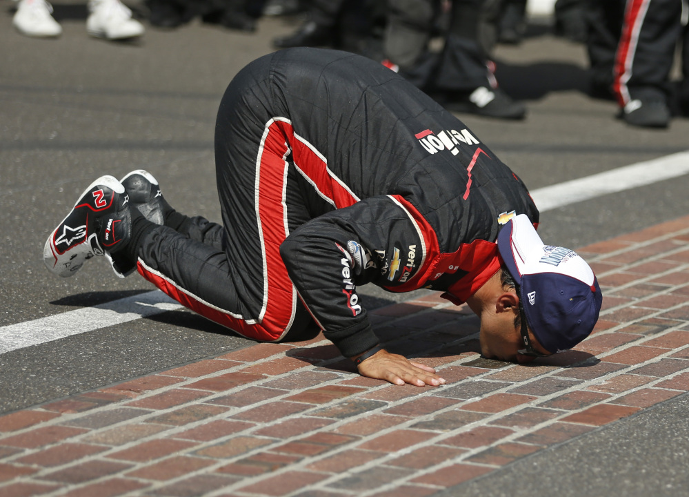 Juan Pablo Montoya kisses the start/finish line after winning the 99th running of the Indianapolis 500 on Sunday at Indianapolis Motor Speedway.