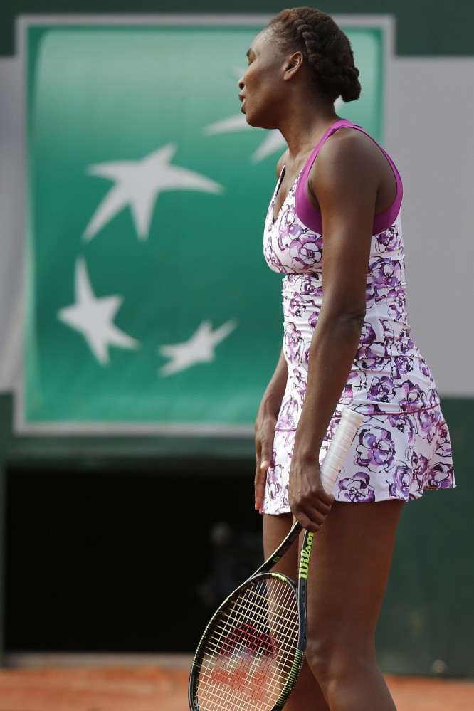 Venus Williams turns away after missing a return in the first round match of the French Open on Monday against Sloane Stephens at the Roland Garros stadium in Paris, France. Stephens beat Williams 7-6 (5), 6-1.