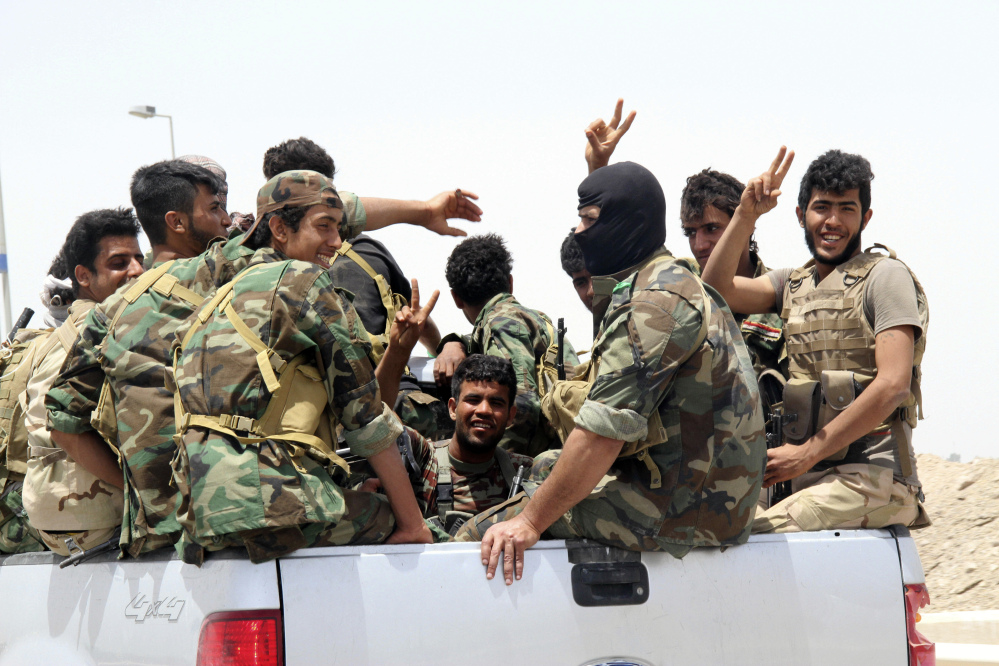 In this Saturday photo, Shiite militiamen arrive to Khalidiya to support Sunni tribal fighters and local policemen as they defend their city against Islamic.