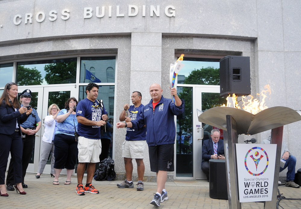 The torch is lit outside the State House in Augusta on Tuesday for the Special Olympics for the first leg of the Law Enforcement Torch Run during a kickoff event.