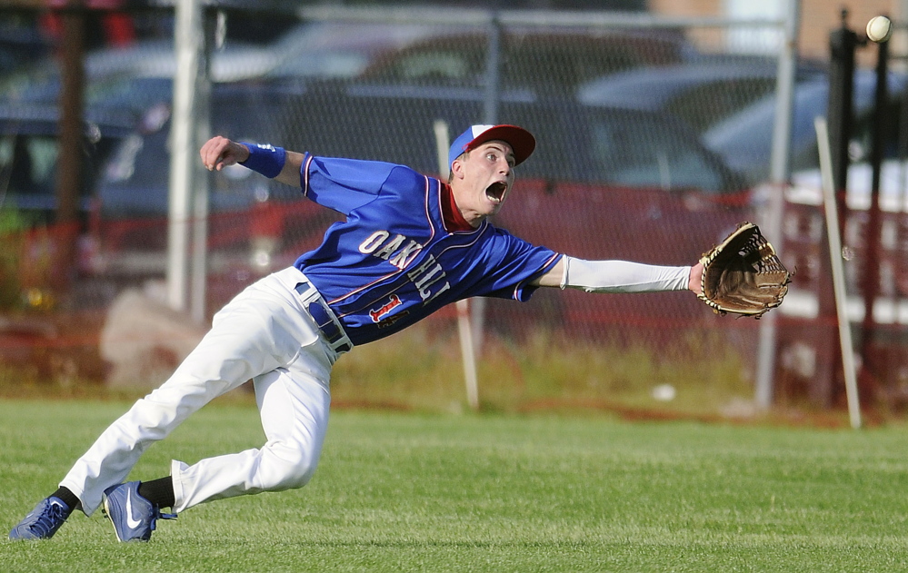 Oak Hill High School’s Connor Nilsson can’t catch a line drive into center during a game against Hall-Dale High School on Tuesday in Farmingdale.