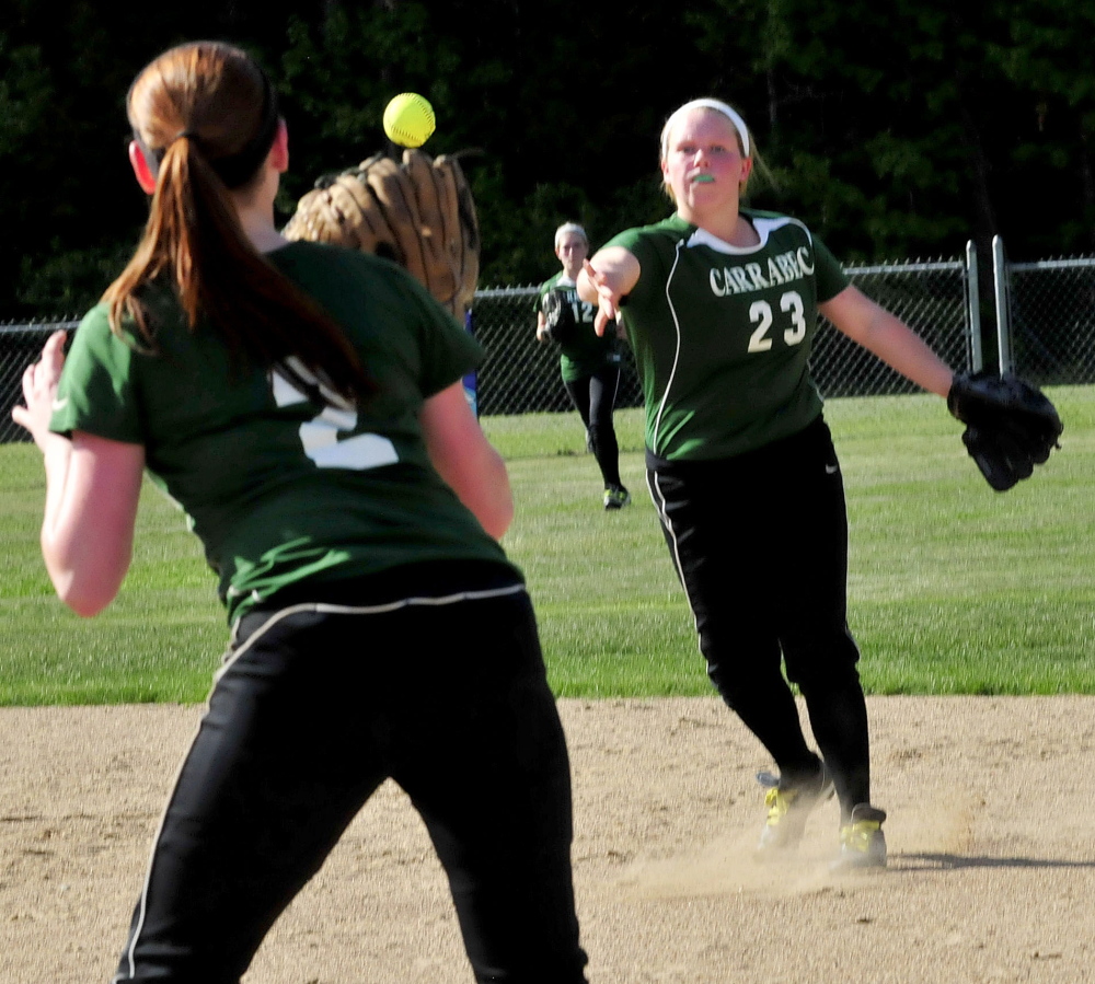 Carrabec’s Lexie Cowan (23) throws to first baseman Brooke Moore for an out during a Mountain Valley Conference game against Madison on Tuesday afternoon. Madison prevailed 6-1.